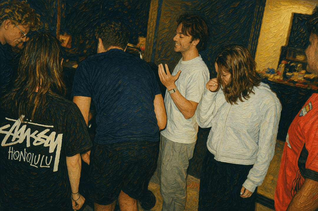 Group of six young people standing closely indoors, some facing away, in casual clothes.